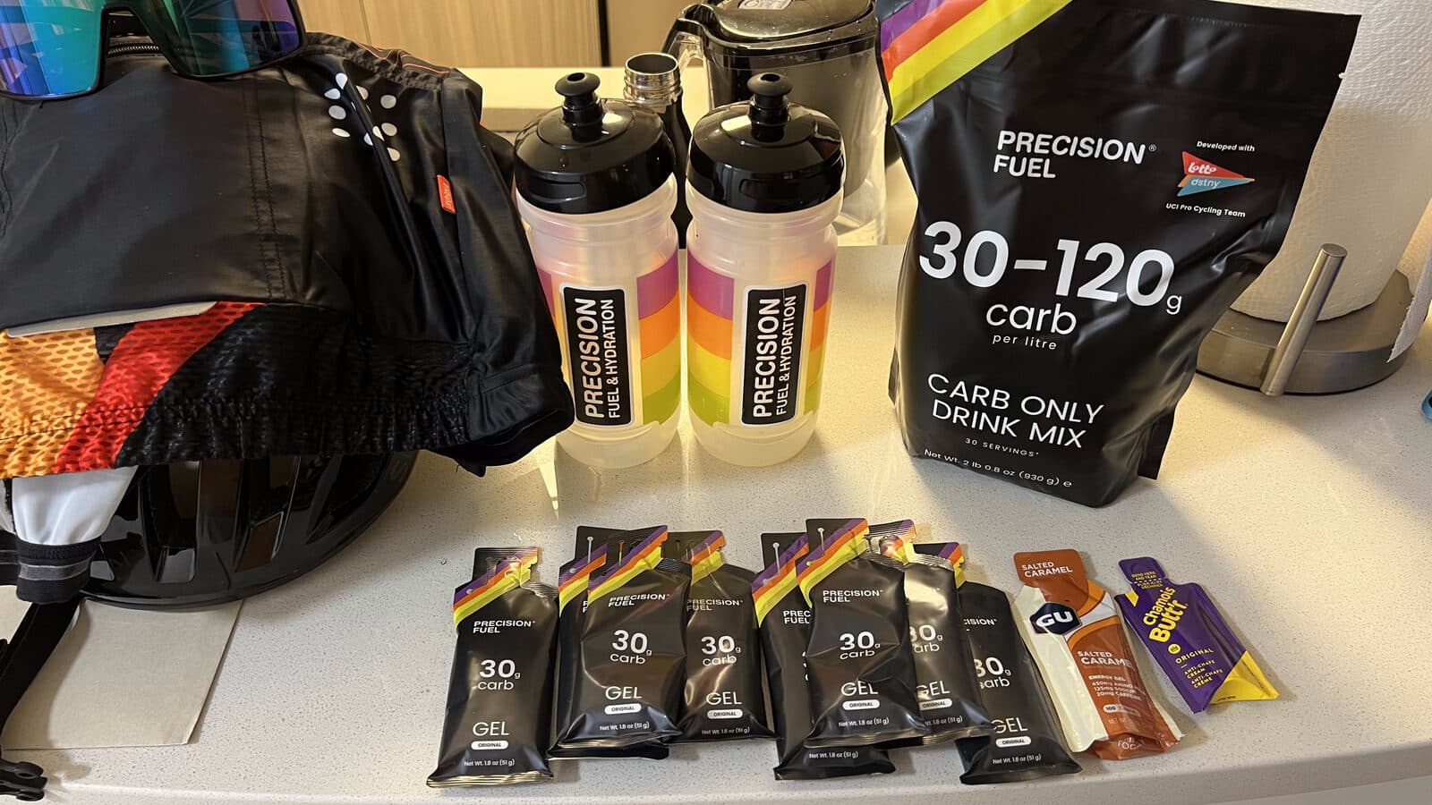 Precision Fuel & Hydration carb drink mix, PF 30 gels, and bottles laid out before a session
